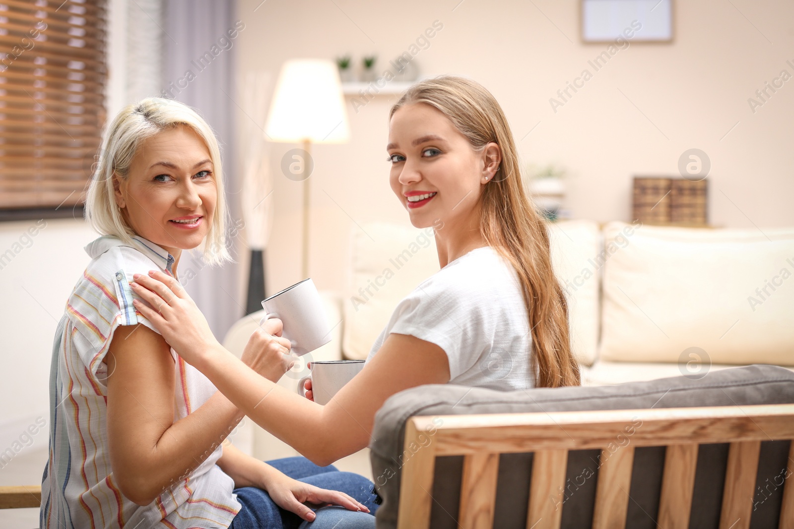 Photo of Mother and her adult daughter spending time together at home