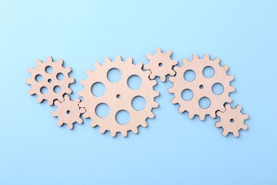 Business process organization and optimization. Scheme with wooden figures on light blue background, top view