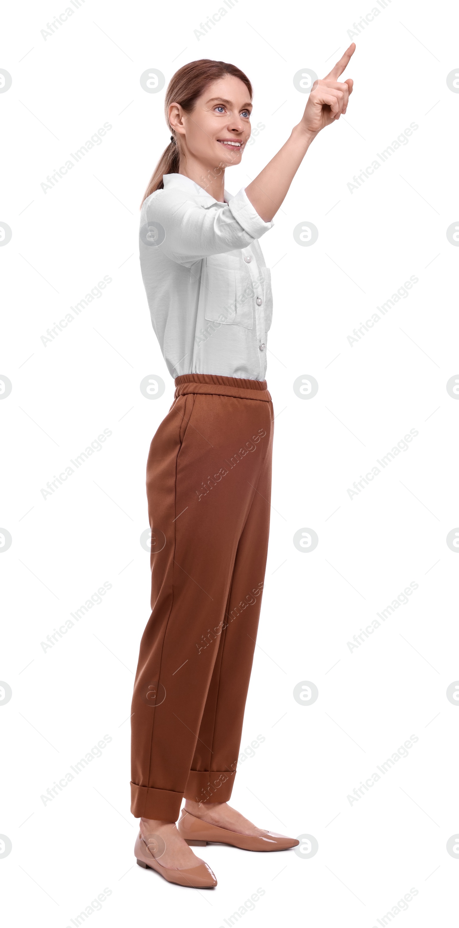 Photo of Beautiful happy businesswoman pointing at something on white background