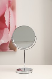 Mirror on white dressing table in makeup room