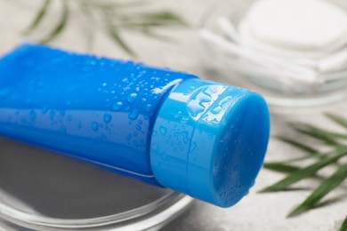 Photo of Tube of face cleansing product on table, closeup