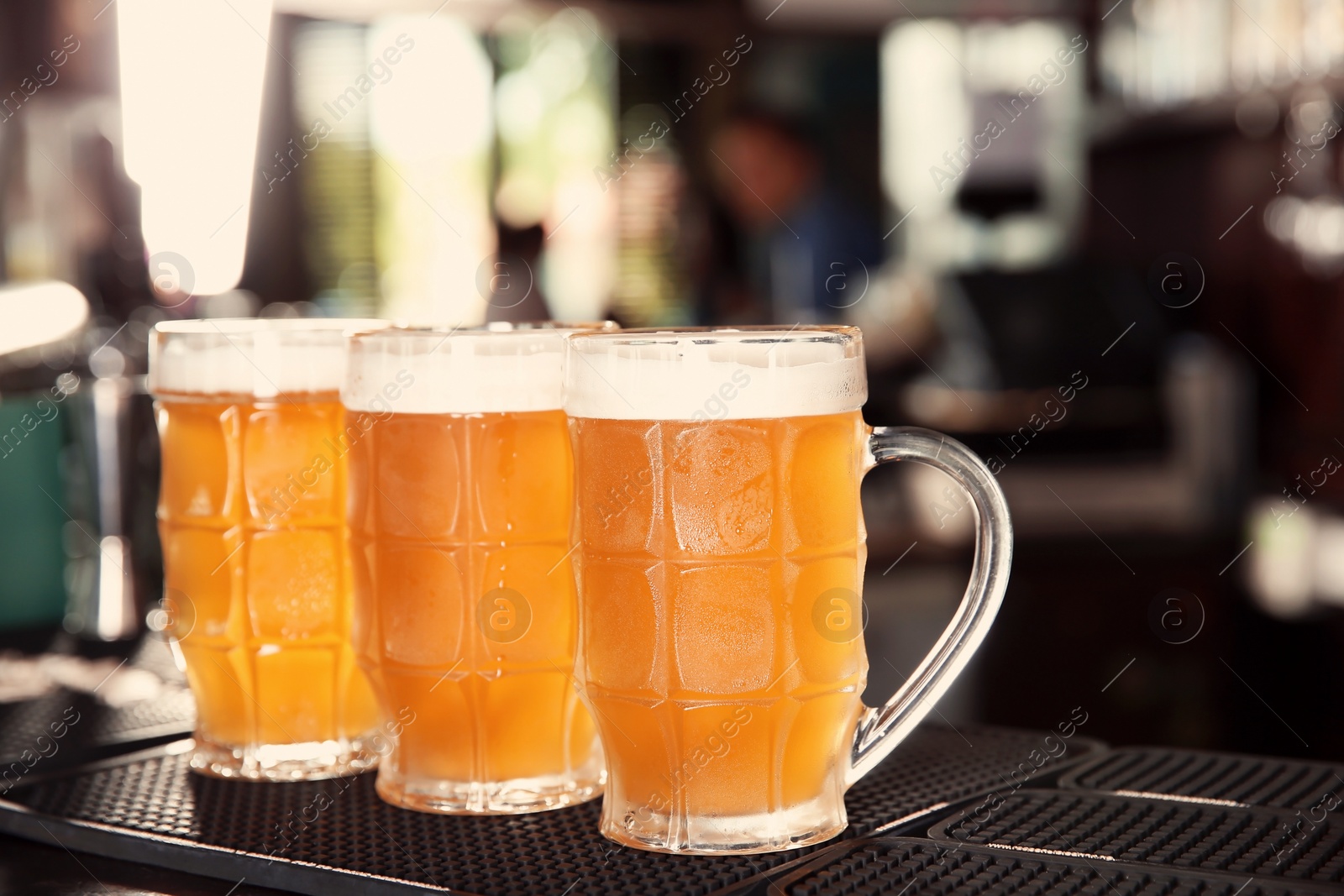 Photo of Glasses of tasty beer on bar counter