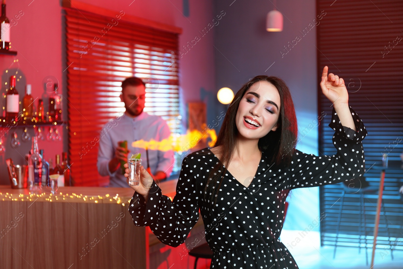 Photo of Young woman with Mexican Tequila shot in bar