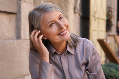 Portrait of beautiful happy senior woman outdoors