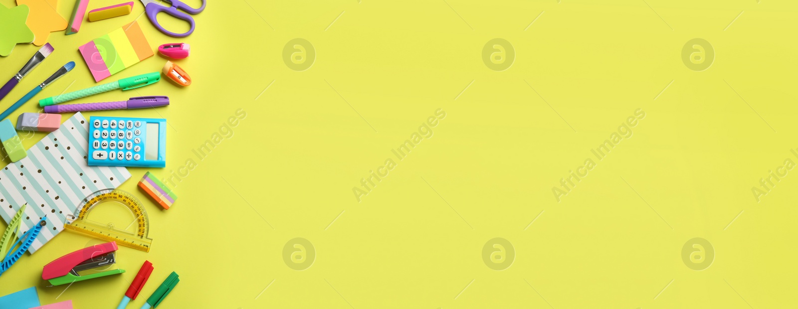 Photo of School stationery on yellow background, flat lay with space for text. Back to school