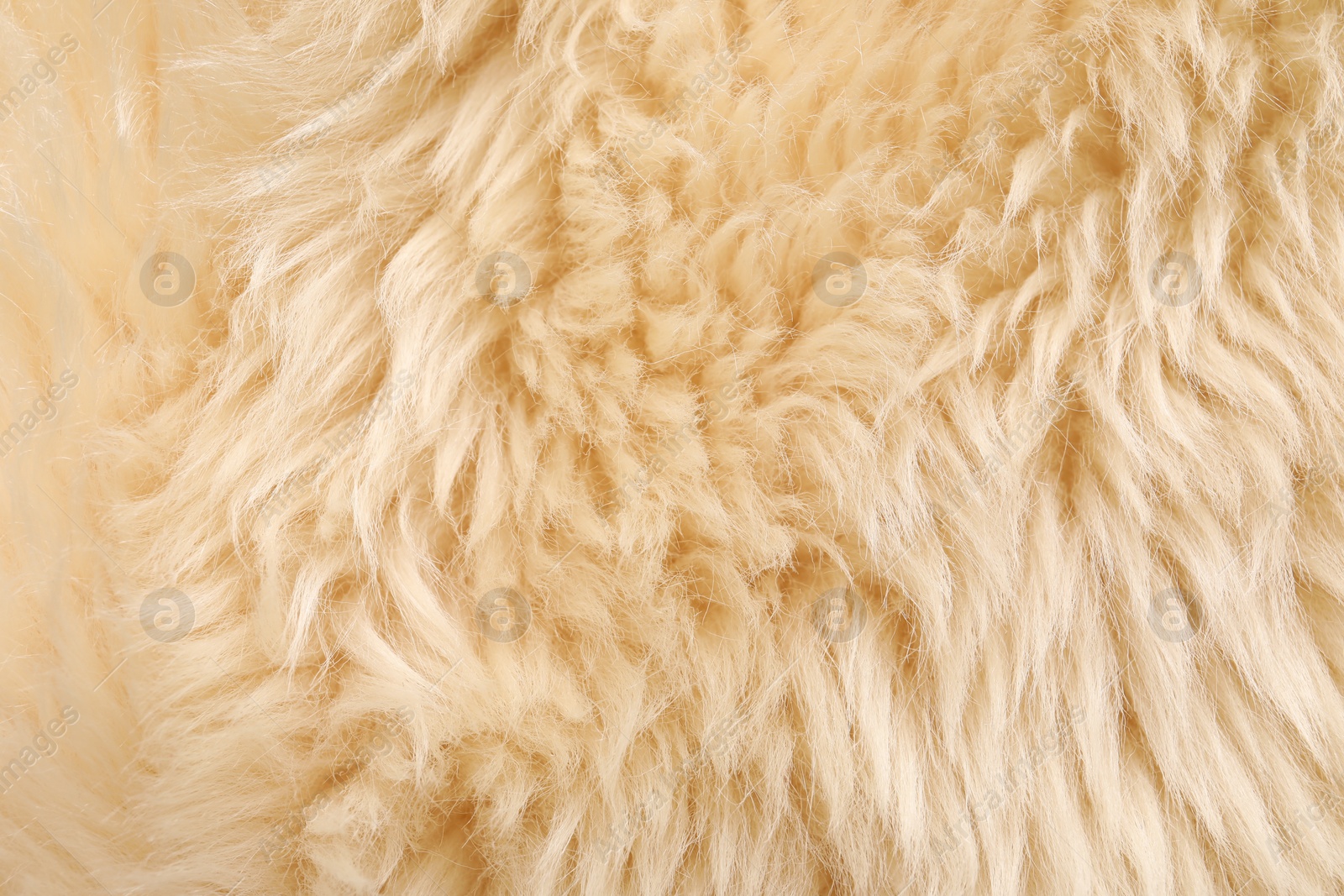 Photo of Texture of beige faux fur as background, top view