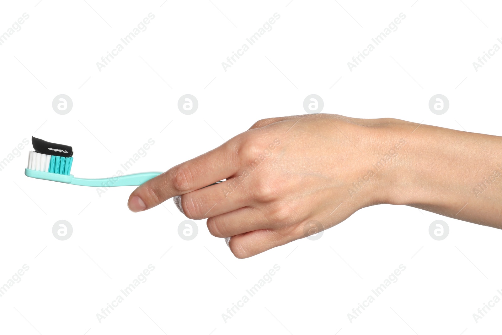 Photo of Woman holding brush with charcoal toothpaste against white background, closeup