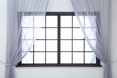 Modern window with curtains in room. Home interior