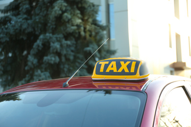 Photo of Roof light with word TAXI on car outdoors