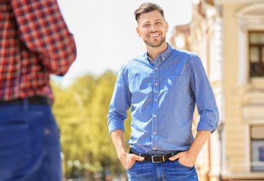 Photo of Portrait of young man in stylish outfit outdoors