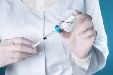 Photo of Doctor with syringe and medicine for vaccination, closeup