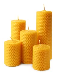 Stylish elegant beeswax candles isolated on white