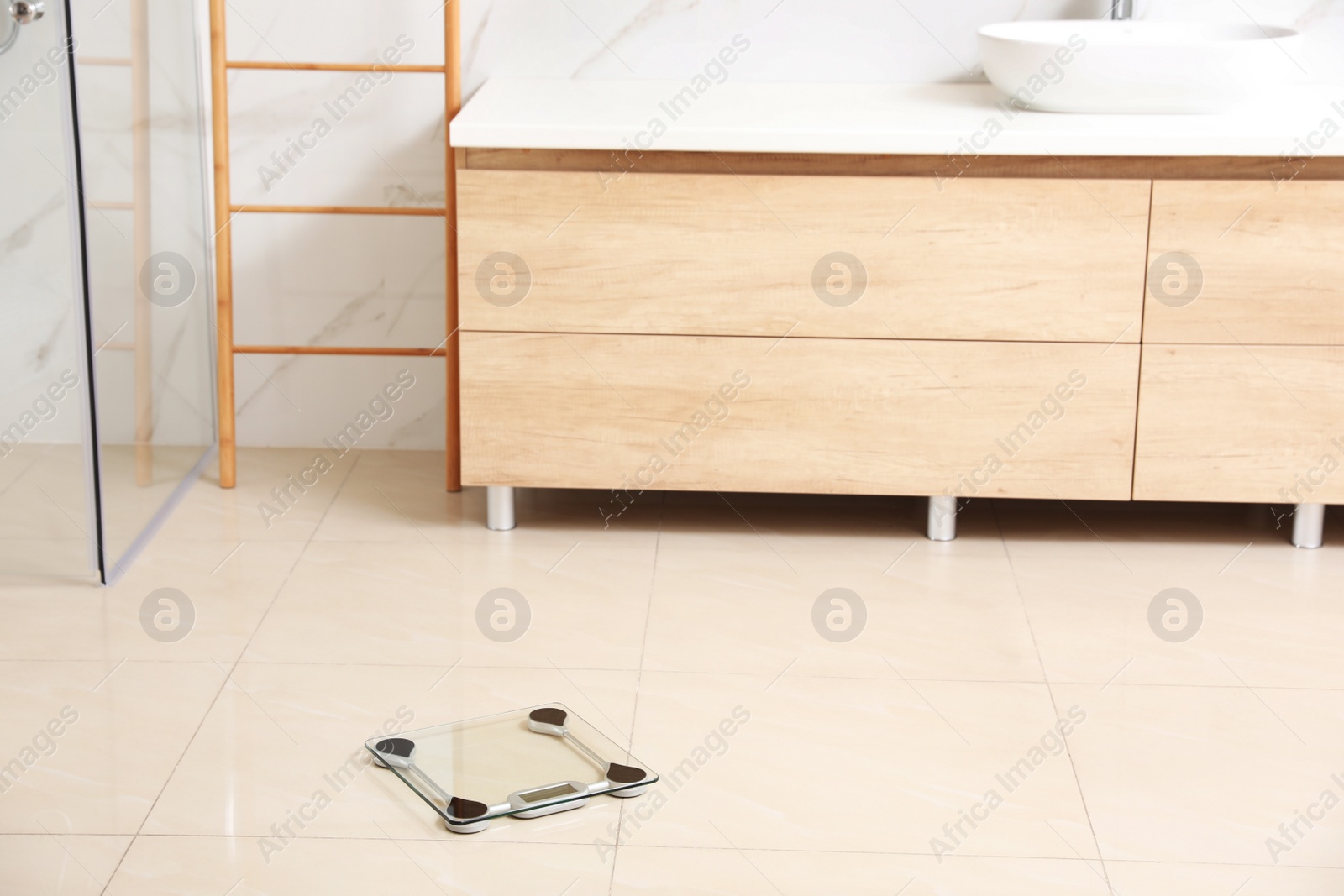 Photo of Scales on floor in bathroom. Overweight problem