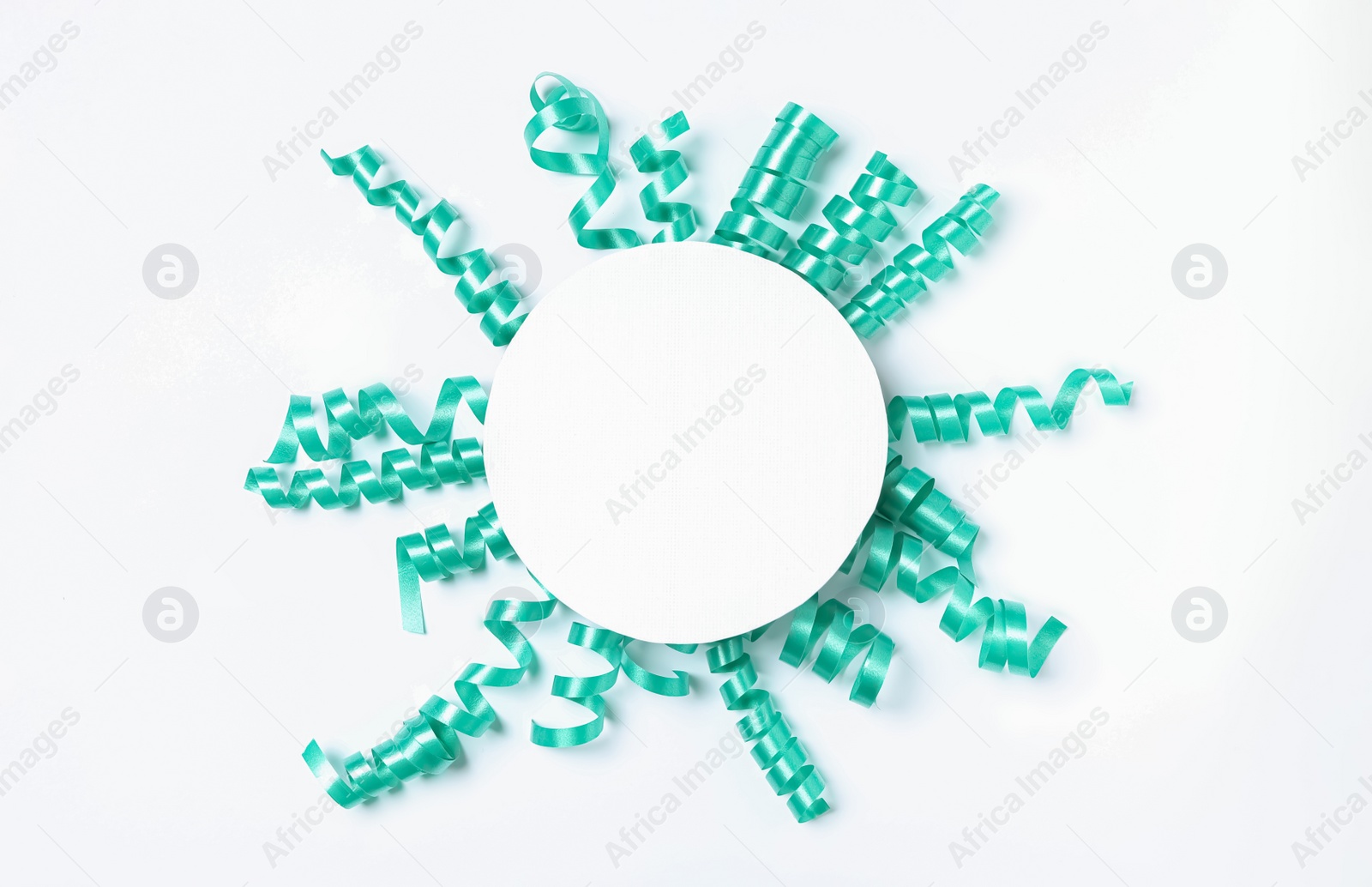 Photo of Blank card and turquoise serpentine streamers on white background, top view