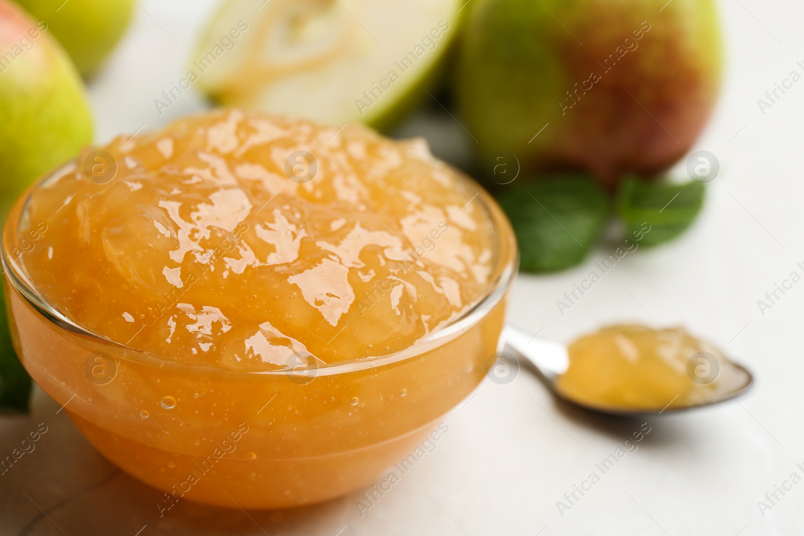 Photo of Delicious pear jam in glass bowl on table, closeup