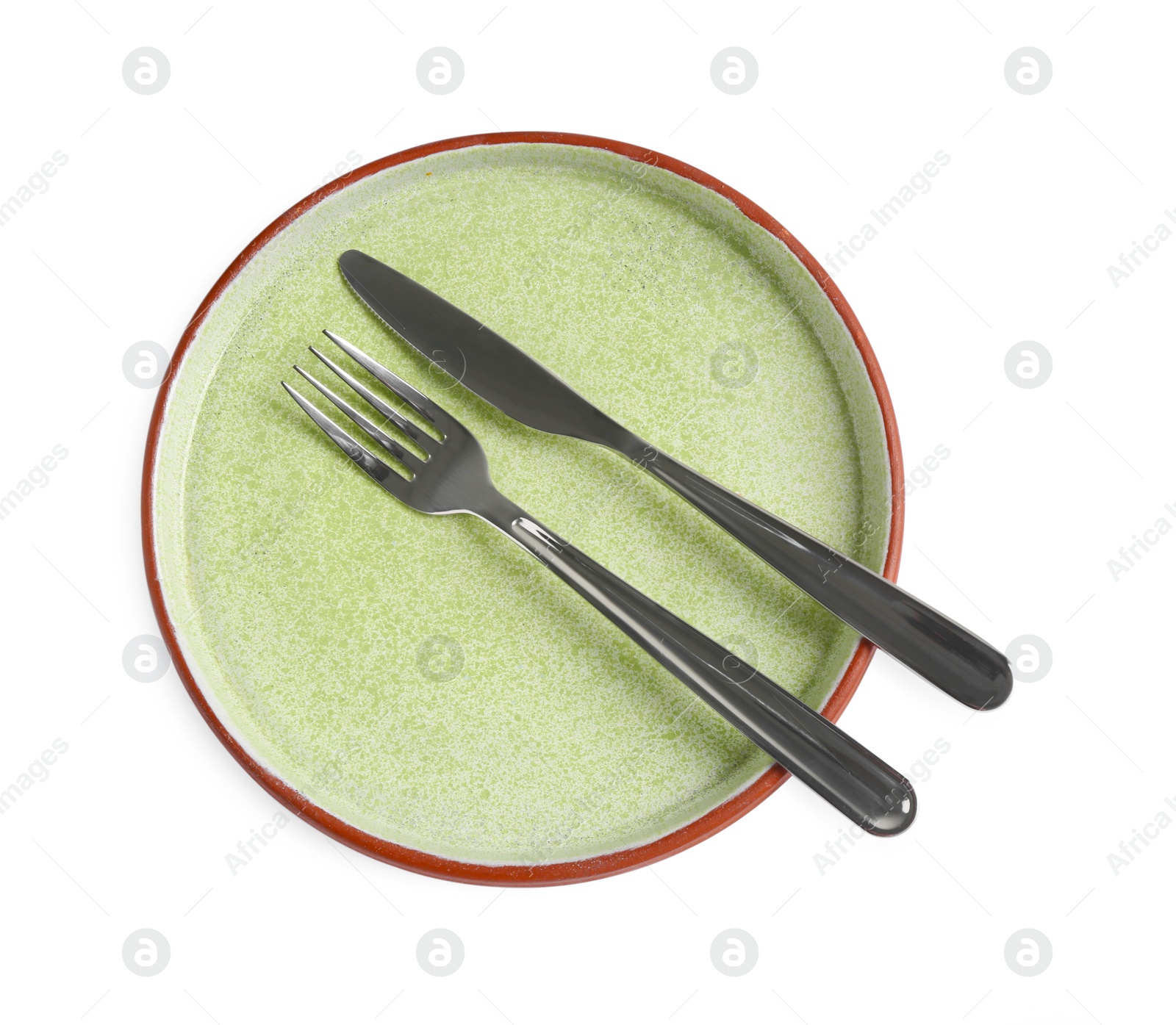 Photo of Ceramic plate, fork and knife on white background, top view