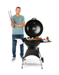 Man cooking on barbecue grill, white background