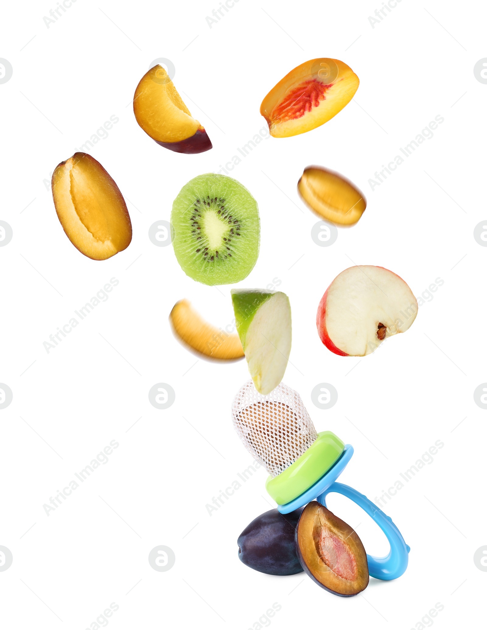 Image of Empty nibbler and pieces of different fruits falling on white background. Baby feeder