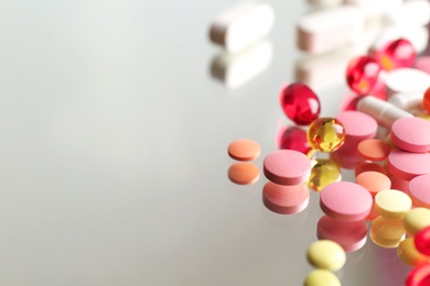 Photo of Colorful pills on reflective surface