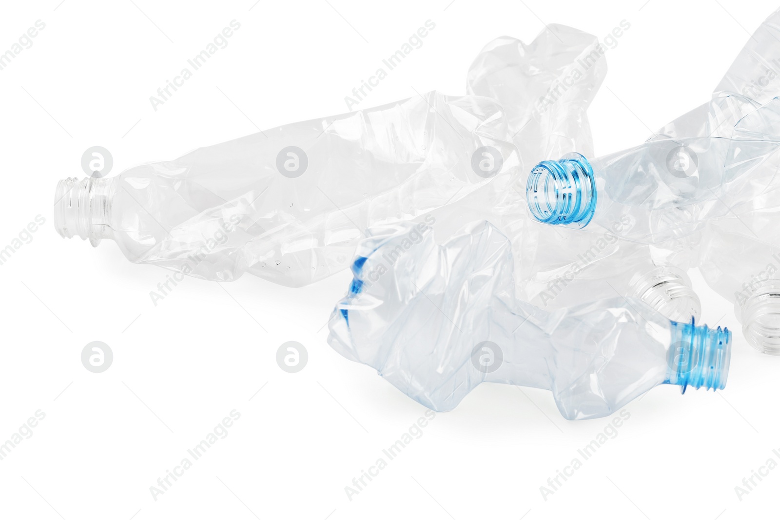 Photo of Crumpled disposable plastic bottles on white background