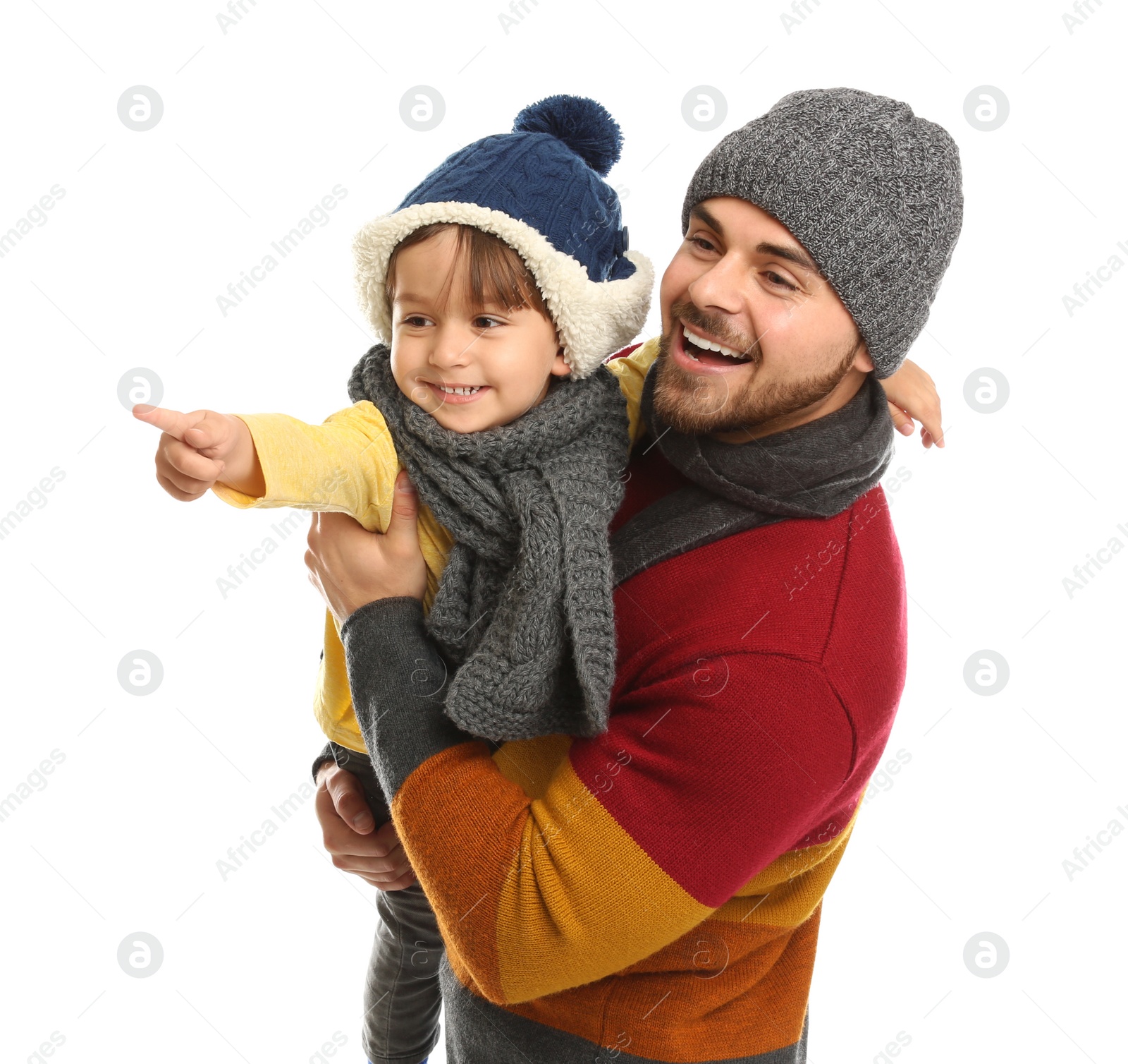 Photo of Happy father and son in warm clothes on white background. Winter vacation