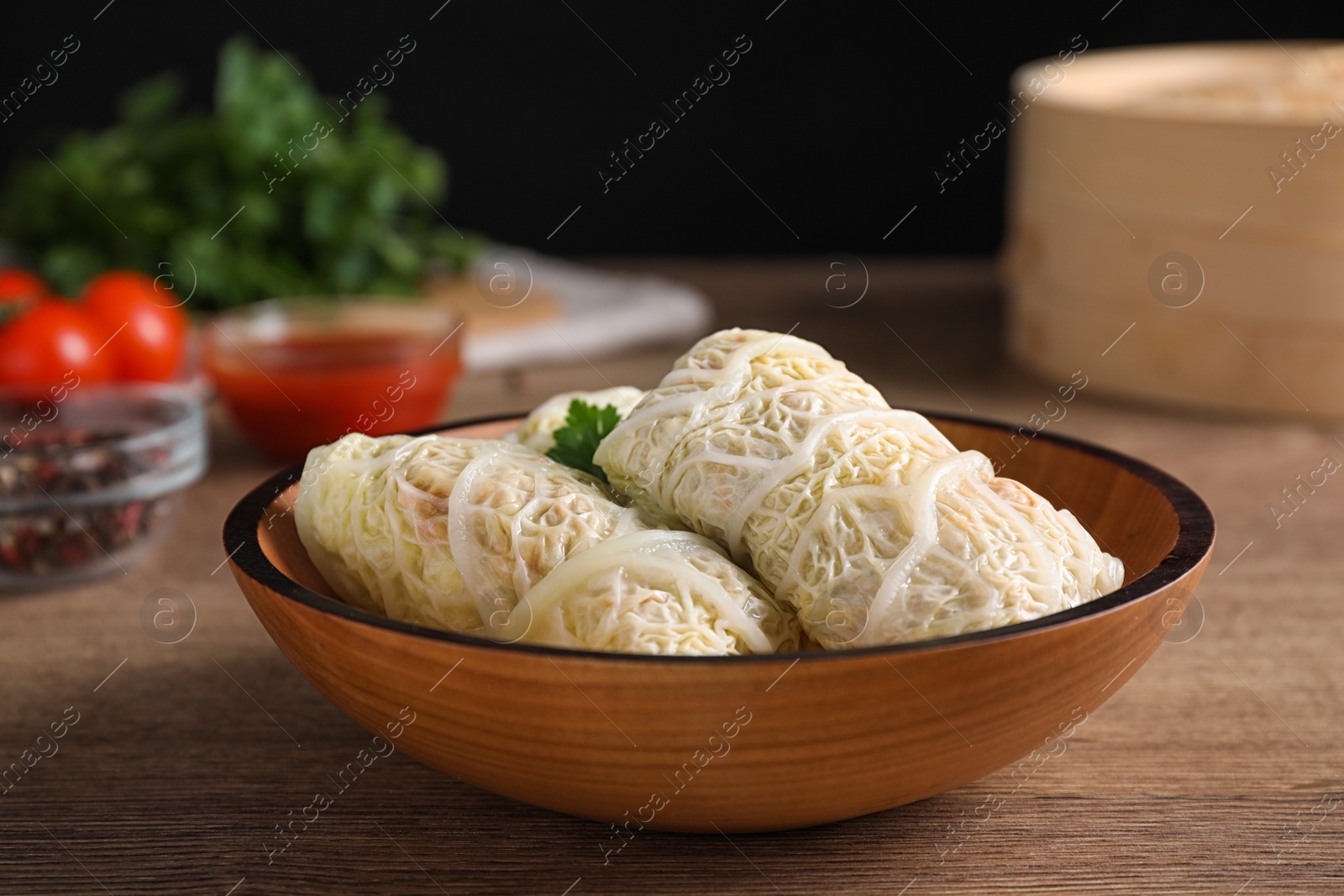 Photo of Delicious cabbage rolls on wooden table, closeup