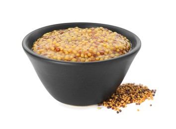 Fresh whole grain mustard in bowl and dry seeds isolated on white