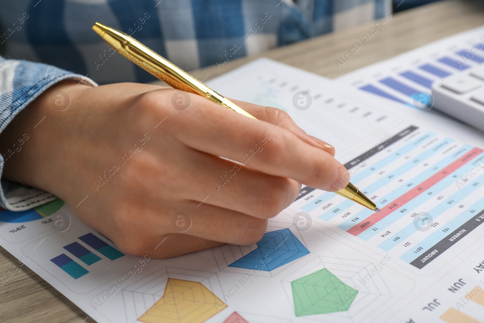 Photo of Woman working with accounting document at table, closeup