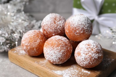 Photo of Delicious sweet buns with powdered sugar on table, closeup