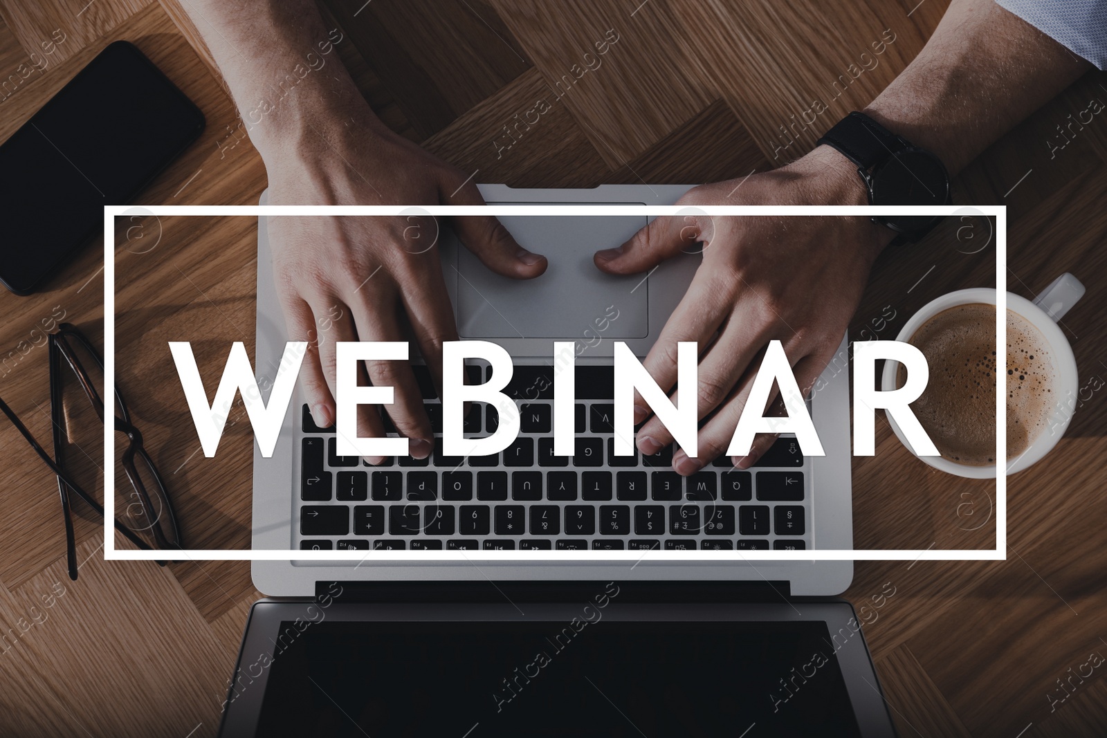 Image of Man with laptop, cup of coffee and smartphone at wooden table, top view. Business webinar