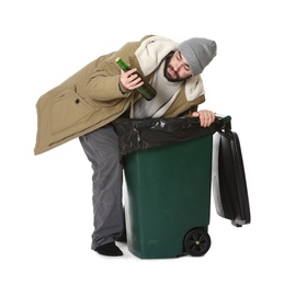 Poor homeless man digging in trash bin isolated on white