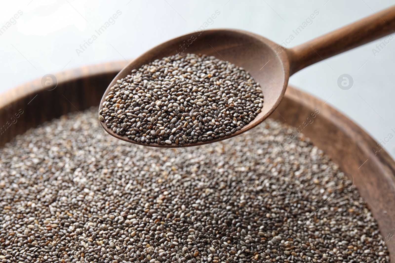 Photo of Closeup of spoon with chia seeds over bowl