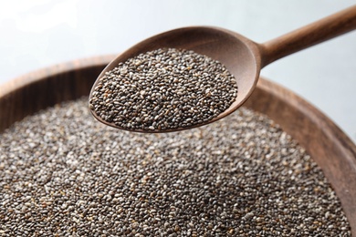 Photo of Closeup of spoon with chia seeds over bowl