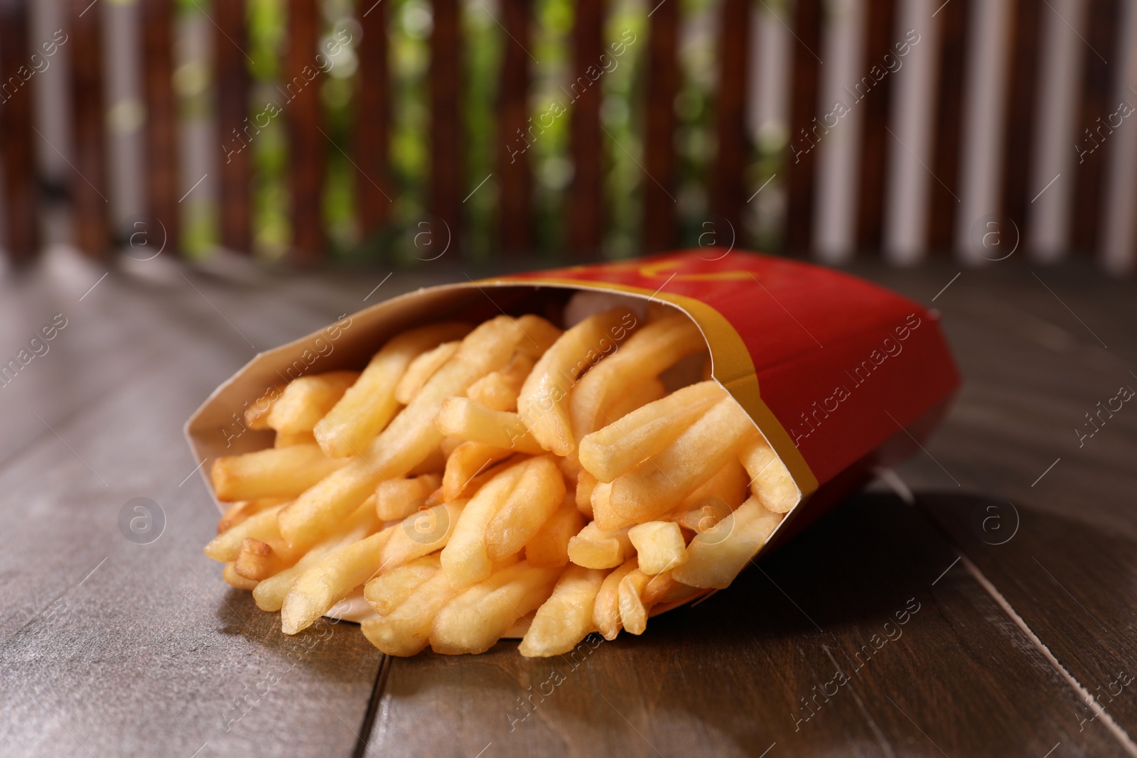 Photo of MYKOLAIV, UKRAINE - AUGUST 12, 2021: Big portion of McDonald's French fries on wooden table, closeup