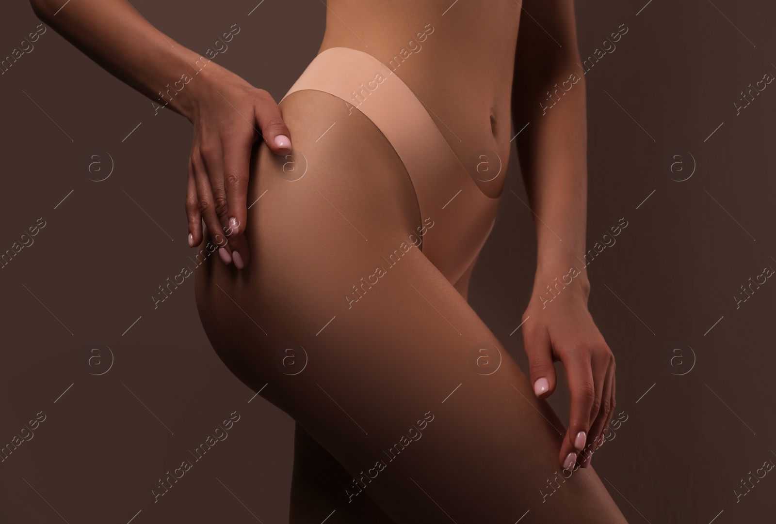 Photo of Closeup view of slim woman in underwear on color background. Cellulite problem concept