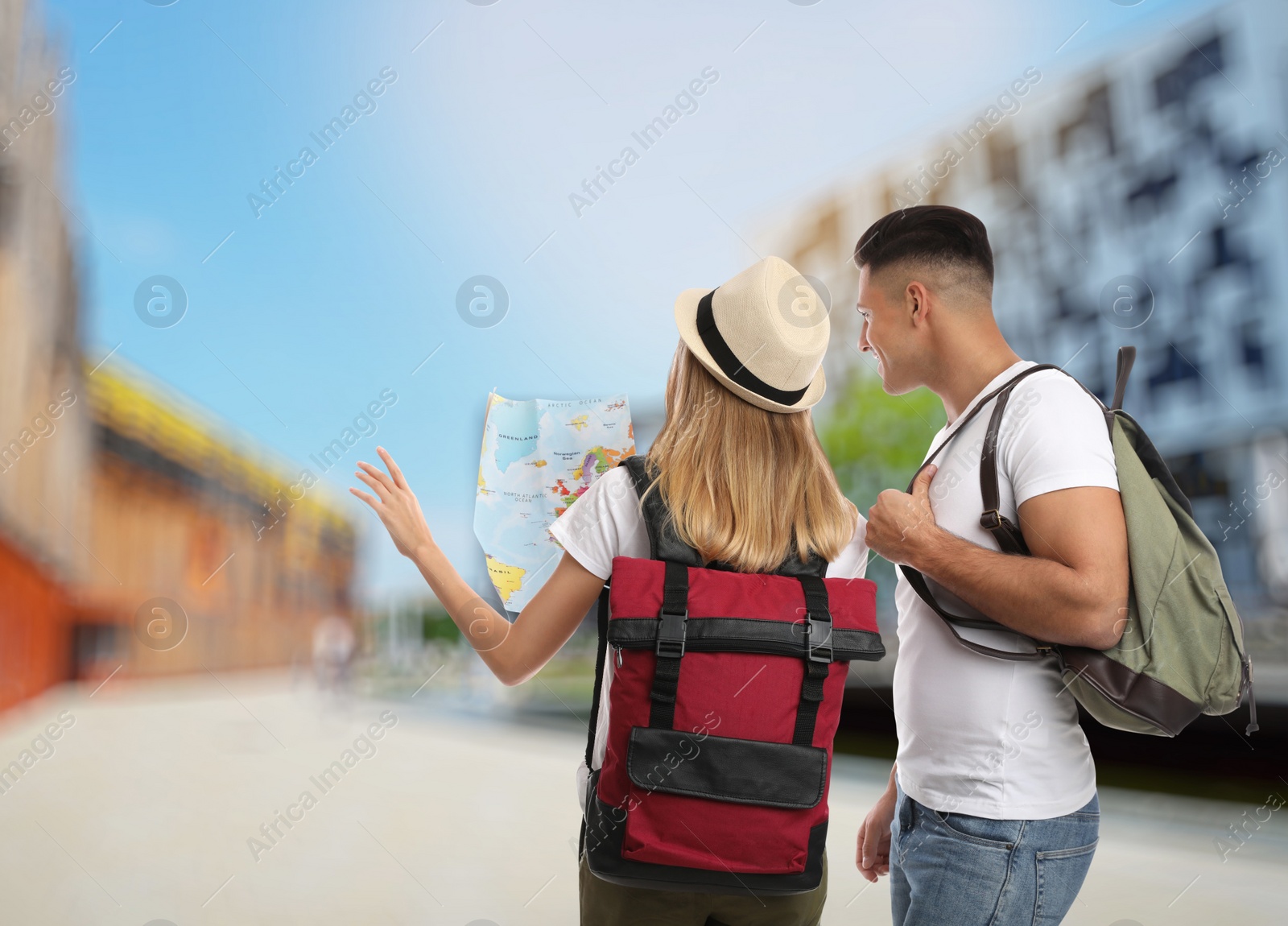 Image of Couple of travelers with map in foreign city. Summer vacation trip
