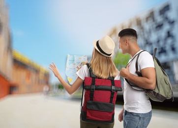 Couple of travelers with map in foreign city. Summer vacation trip