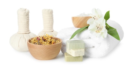 Photo of Spa composition. Towel, herbal massage bags, sea salt, soap and dry flowers on white background