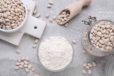Bean flour and seeds on light grey table, flat lay