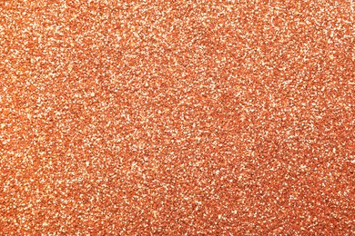 Beautiful shiny peach glitter as background, closeup