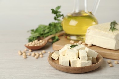 Pieces of delicious tofu with rosemary and soy on white table, closeup. Space for text