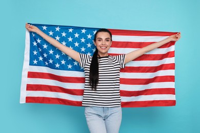 Photo of 4th of July - Independence Day of USA. Happy woman with American flag on light blue background