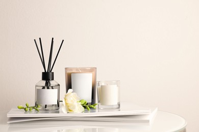 Composition with aromatic reed air freshener on white table, space for text