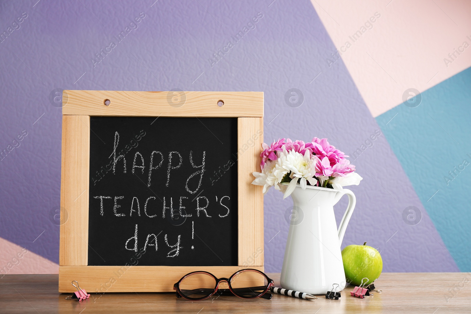 Photo of Composition with small chalkboard for Teacher's day on table