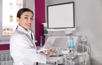 Photo of Sonographer using modern ultrasound machine in clinic