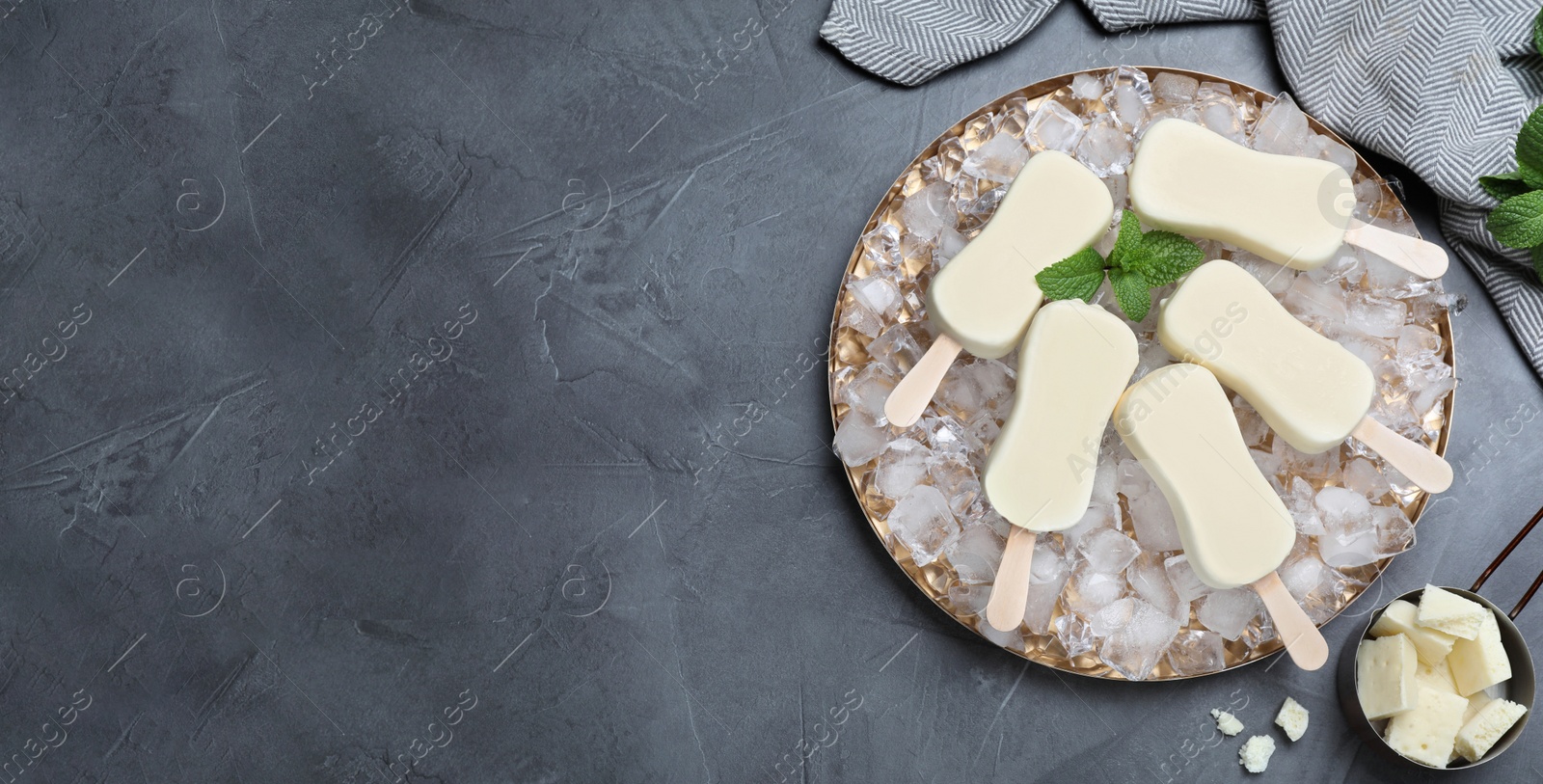 Image of Flat lay composition with glazed ice cream bars, fresh mint and chocolate on grey table, space for text. Banner design