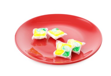 Photo of Red plate with many dishwasher detergent pods on white background