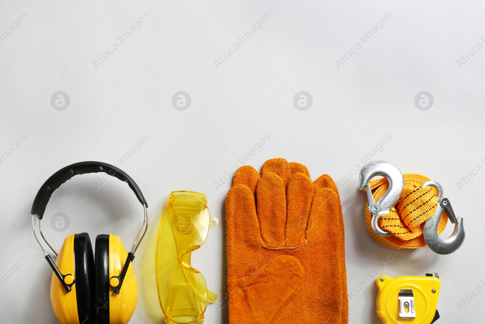 Photo of Flat lay composition with safety equipment and space for text on light background