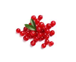 Photo of Pile of fresh cranberries with green leaves on white background, top view