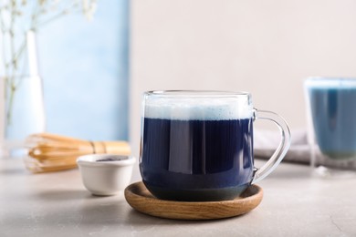 Photo of Delicious blue matcha drink on light grey table